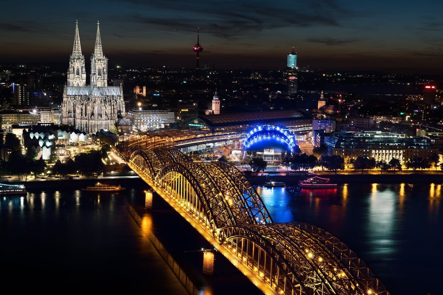 Cologne skyline at night time featuring the lit up Gothic Cathedral. One of the main sights for this section of the London to Vienna tour.
